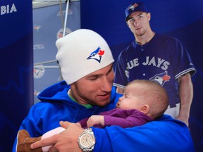 Toronto Blue Jays infielder Brett Lawrie greets three-month-old Athena Farrell at St. Laurent Shopping Centre on Sunday during the team's Winter Tour, which is in Ottawa until Monday. (Tony Caldwell, Ottawa Sun)