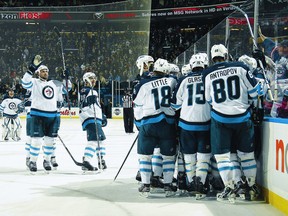 Jets celebrate their overtime triumph over the Buffalo Sabres on Saturday  after losses to Montreal and Toronto. A win against the Bruins on Tuesday would be a good indication that the Jets are true contenders for an Eastern Conference playoff spot. (DAVE SANDFORD/AFP-Getty Images)