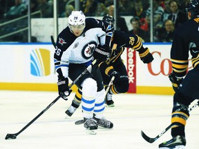 Wheeler heads into the zone as Buffalo Sabres defenceman Robyn Regehr back checks during the third period on Satuday. (KEVIN HOFFMAN/US Presswire)