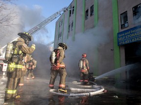Toronto firefighters battle a four-alarm fire at a storage building on Pelham Ave. Monday morning. (Dave Abel/Toronto Sun)