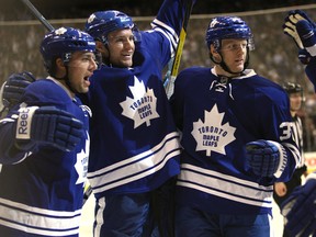 Joffrey Lupul (left) celebrates his winning goal with Cody Franson and Carl Gunnarsson as the Toronto Maple Leafs beat the Detroit Red Wings 4-3 at the Air Canada Centre in Toronto on Saturday, January 7, 2012. (MICHAEL PEAKE/TORONTO SUN)