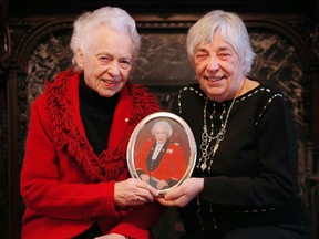 Sisters Grete Hale, left, and Gay Cook, hold a picture of their sister, Jean Pigott, who past away Tuesday, January 10, 2012, at 87 in the same place she was born.
(DARREN BROWN/OTTAWA SUN)