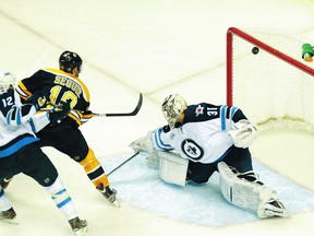 Boston Bruins centre Tyler Seguin scores the go-ahead goal past Winnipeg Jets goalie Ondrej Pavelec Tuesday during the third period at TD Garden. (BOB DECHIARA/US Presswire)