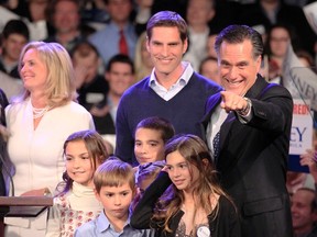 Republican presidential candidate and former Massachusetts Governor Mitt Romney points to supporters as he stands on stage with his relatives while speaking at his New Hampshire primary night rally in Manchester, New Hampshire, January 10, 2012. (REUTERS/Jim Bourg)
