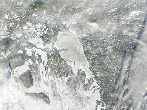 A satellite image of a frozen Lake Winnipeg. (COURTESY EOSNAP.COM)