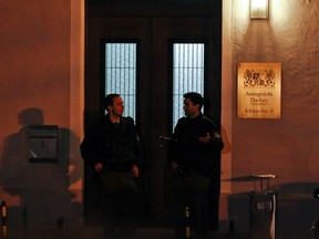 Policemen stand in front of a regional court after a shooting in Dachau near Munich January 11, 2012. A man opened fire and killed the prosecutor during his trial earlier today, German media reported.   REUTERS/Michael Dalder