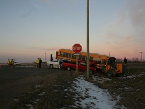 A 40-year-old female school bus driver from Winnipeg has been charged after a three-vehicle collision on the Trans-Canada Highway on Nov. 24, 2011. There were no passengers on the bus when it was struck by two pickup trucks near Dusfresne, Man., southeast of Winnipeg. (Handout)