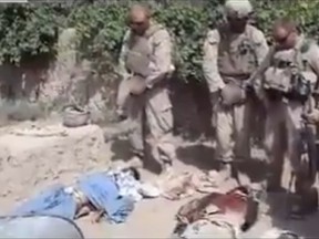 A video posted on YouTube shows four men in camouflage Marine combat uniforms urinating on the bodies of three dead Taliban.