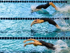 Swimmers dive into the pool at the start of the women's 100 meter backstroke preliminary races during the AT&T Winter National Championships in Atlanta, Georgia December 2, 2011. (REUTERS/Chris Keane)