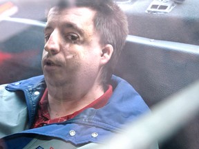 Stanley Tippett sits inside a police cruiser outside the courthouse in Peterborough, Ont., Oct. 31, 2011. (QMI Agency files)