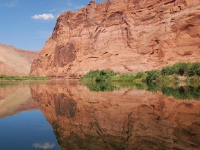 The Colorado River reflects the sky and tall cliffs inside Arizona’s Glen Canyon. The stunning canyon is a big draw for photographers and nature buffs. (Wayne Newton/ Special to QMI Agency)
