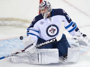 Pavelec makes a save against the Montreal Canadiens Jan. 4. (QMI Agency files)