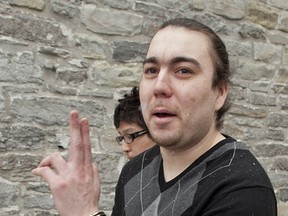 Justin Boyer gestures to a reporter as he is escorted to a prisoner's van on Jan. 12, 2012 at Superior Court in Peterborough. Boyer pleaded guilty to aggravated assault on Stevenson Auguste who was killed during a fight at Thursday's Bar in January 2010. CLIFFORD SKARSTEDT/QMI Agency