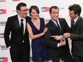 Actor Jean Dujardin  holds the award for best picture for "the Artist" as director Michel Hazanavicius, left, actress Berenice Bejo and producer Thomas Langmann celebrate their win at the 2012 Critics' Choice Awards in Los Angeles January 12, 2012. (REUTERS/Danny Moloshok)