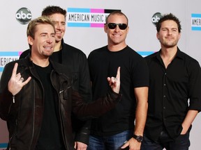 Rock band Nickelback poses on arrival at the 2011 American Music Awards in Los Angeles November 20, 2011.  (REUTERS/Danny Moloshok)