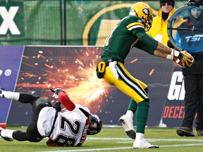 Edmonton's Jason Barnes avoids being hit by Calgary's  Brandon Smith during the Edmonton Eskimos CFL football western semi-final game against the Calgary Stampeders at Commonwealth Stadium in Edmonton on Sunday, November 13, 2011. (CODIE MCLACHLAN/EDMONTON SUN)