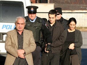 Mohammad Shafia, left, his wife Tooba Mohammad Yahya, and their son, Hamed arrive for court in Kingston on December 12 2011. (IAN MACALPINE/QMI Agency)