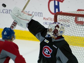 Goalie Carey Price turns aside a shot during Canadiens practice on Friday in Montreal. The netminder will make the start Saturday against the visiting Senators. (Ben Pelosse/QMI Agency)