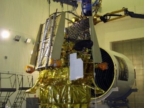 Employees work on the Phobos-Grunt (Phobos-Soil) spacecraft at the Baikonur comosdrome in Kazakhstan October 31, 2011. (REUTERS/Oleg Urusov)