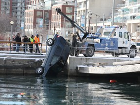 Toronto Police Marine Unit investigate and remove a vehicle for Lake Ontario on Saturday, January 14, 2011 in Toronto.A man is facing impaired driving charges and is now in the hospital after the car plunged into the water at Lower Spadina Ave and Queen's Quay.(Veronica Henri/QMI Agency)