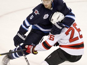 Winnipeg Jets defenceman Ron Hainsey (left) is all for hybrid icing, which will help prevent injuries to blue-liners.