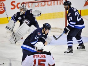 Wheeler (26)holds his neck after getting hit with puck. (FRED GREENSLADE/Reuters)