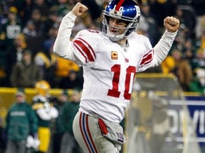 New York Giants quarterback Eli Manning celebrates after a touchdown by Brandon Jacobs against the Green Bay Packers in the fourth quarter during their NFL NFC Divisional playoff football game in Green Bay, Wisconsin, January 15, 2012. REUTERS/Jeff Haynes
