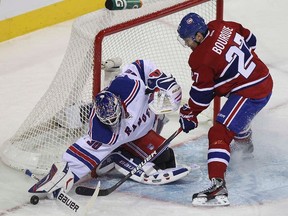 New York Rangers’ goalie Henrik Lundqvist (30) makes save against Montreal Canadiens’ Rene Bourque (27) during first period NHL hockey action in Montreal, January 15, 2012. REUTERS/Christinne Muschi