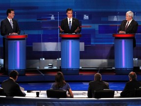 Republican presidential candidate former Massachusetts Governor Mitt Romney (C) speaks as former U.S. Senator Rick Santorum (R-PA) and former House Speaker Newt Gingrich (R) look on during the Republican presidential candidates debate in Myrtle Beach, South Carolina, January 16, 2012. REUTERS/Jason Reed