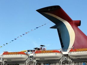 Passengers stand near life boats after boarding the cruise ship Carnival Imagination at the Port Of Miami, Florida, January 16, 2012. Reuters/Robert Sullivan