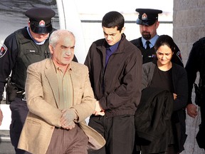 Mohammad Shafia (left) Tooba Mohammad Yahya and their son Hamed enter Frontenac County courthouse in Kingston on Monday, January 16, 2012 for their murder trial. (IAN MACALPINE/Postmedia Network)