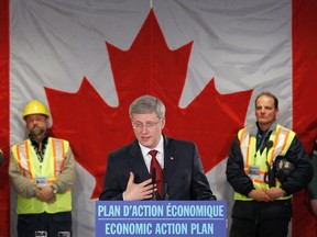Canada’s Prime Minister Stephen Harper (C) speaks during a news conference in Saguenay, Quebec, January 17, 2012. REUTERS/Mathieu Belanger