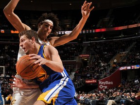 Golden State Warriors David Lee drives to the basket against Cleveland Cavaliers Anderson Varejao at The Quicken Loans Arena on January 17, 2012 in Cleveland, Ohio. (David Liam Kyle/NBAE via Getty Images/AFP)