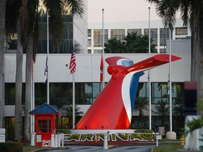 Flags are shown at half-mast outside the headquarters of Carnival Cruise Lines in Doral, Florida, January 17, 2012. Carnival is the parent company of Costa, operator of the Costa Concordia which was grounded off the coast of Italy. REUTERS/Joe Skipper