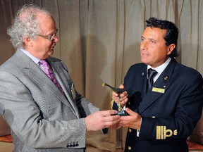Ross Gaudreault gives Captain Francesco Schettino of Costa Atlantica a sculpture to congratulate him on docking the first ship in Quebec to start the cruise season, in this file photo taken on Friday, April 23, 2010. (Didier Debusschere/QMI AGENCY)