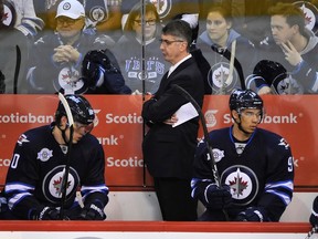 Jets coach Claude Noel and players Nik Antropov (left) and Evander Kane look glum during the waning moments of their loss to the San Jose Sharks last week. The Jets can be hard to figure out, looking like hard-working world beaters one night and overmatched squad that can’t play defence the next. (FRED GREENSLADE/REUTERS)