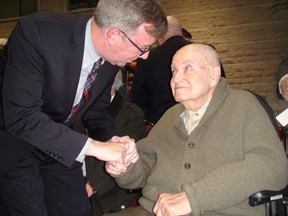 Jean Pigott's husband, Arthur, speaks with Mayor Jim Watson on January 18, at his wife's memorial service at City Hall Thursday. (LARISSA CAHUTE / OTTAWA SUN / QMI AGENCY)