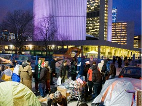 Home they go: The Occupy Toronto crowd dismantled their eight tents Thursday evening after being served with an eviction notice from the province to vacate land at City Hall.