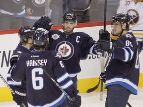 Winnipeg Jets (from left) Alexander Burmistrov, Ron Hainsey, Andrew Ladd and Nik Antropov celebrate Hainsey's first period goal against the Buffalo Sabres during NHL hockey in Winnipeg Thursday, Jan. 19, 2012. (Brian Donogh, Winnipeg Sun)