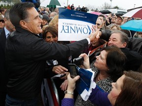 U.S. Republican presidential candidate Mitt Romney greets supporters during a campaign rally in Gilbert, South Carolina, January 20, 2012. REUTERS/Jim Young