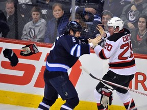 Stuart drops the gloves with New Jersey Devils' Ryan Carter January 14 in Winnipeg. (FRED GREENSLADE/Reuters files)