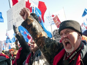 Nick Shearman, CAW Local 112 chairperson of the Brinks Toronto Unit, shouts as he thrusts his fist into the air during a labour rally in Victoria Park on Saturday January 21, 2012.  Around 5,000 labour supporters from across Ontario and parts of the United States converged on London in support of nearly 500 workers who have been locked out of Electro-Motive Diesel's London plant since January 1st.
(CRAIG GLOVER/QMI AGENCY)