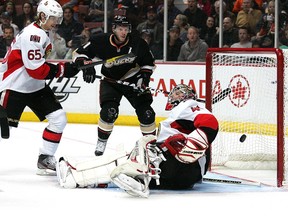 Ottawa Senators defenceman Erik Karlsson watches as the puck goes past goalie Craig Anderson and into the net after it deflected off his stick after a shot by Anaheim Ducks defenceman Lubomir Visnovsky (not pictured) at the Honda Centre in Anaheim on Saturday. (Jake Roth-US PRESSWIRE)