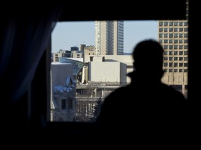 A resident of a building near the Ottawa Convention Centre shows the view they have of the Ottawa Convention Centre and the image projection wall that many area residents have concerns about. 
(ERROL MCGIHON/OTTAWA SUN)