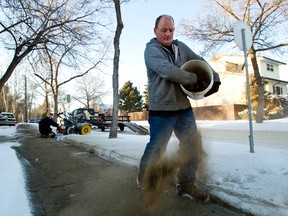 Ken Anderson spreads sidewalk sand along 106 Street and 71 Avenue in Edmonton on Sunday, January 22, 2012. CODIE MCLACHLAN/EDMONTON SUN QMI AGENCY