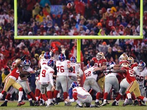 New York Giants kicker Lawrence Tynes (9) kicks the game winning field goal against the San Francisco 49ers during overtime in the NFL NFC Championship game in San Francisco, California, January 22, 2012.  REUTERS/Mike Blake