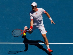 Andy Murray of Britain hits a return to Mikhail Kukushkin of Kazakhstan during their men’s singles match at the Australian Open tennis tournament in Melbourne January 23, 2012.    REUTERS/Daniel Munoz