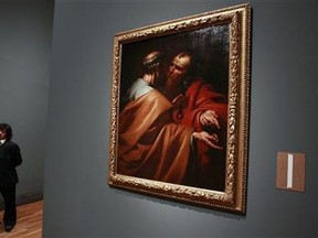 A worker stands by the painting "San Pedro y San Pablo" (Saint Peter and Saint Paul) by Spanish artist Jose de Ribera during a preview of the upcoming exhibition "The Young Ribera" at Madrid's El Prado museum April 1, 2011. Reuters/Andrea Comas