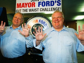 Councillor Doug Ford holds up nine fingers to reflect the pounds he's lost — one shy of brother Mayor Rob Ford's ten pounds, during their first-week weigh-in at City Hall Monday. (Craig Robertson/Toronto Sun)