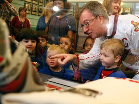 In advance of the 2012 NHL All-Star Game, Mayor Jim Watson shows children from St. Luke's Child Care Centre the new hockey memorabilia in the Ottawa Sports Hall of Fame Monday, January 23, 2012 inside City Hall. (DARREN BROWN/QMI AGENCY)